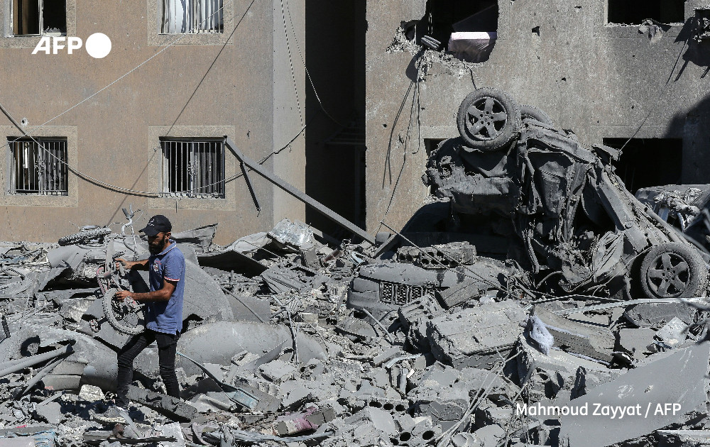 Men sift through the rubble of a building in a area targeted overnight by Israeli airstrikes in Lebanon.